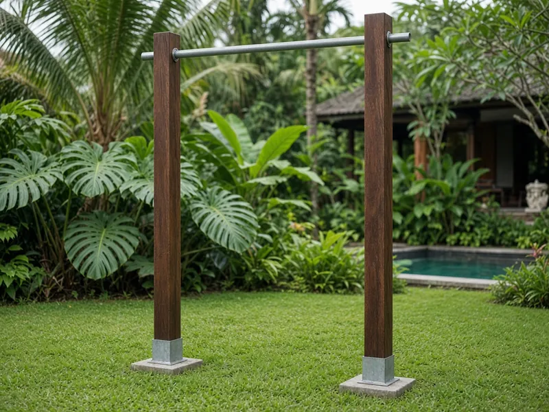 Freestanding pull-up bar on two bengkirai posts in a villa garden